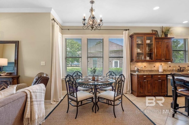 dining room with light tile patterned floors, baseboards, ornamental molding, a notable chandelier, and recessed lighting