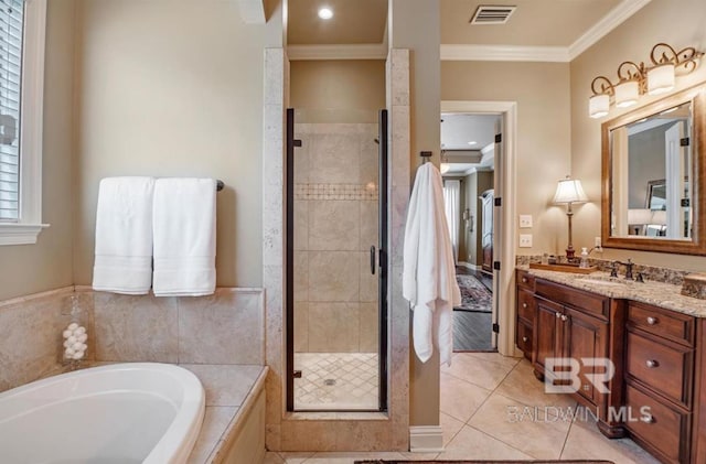 bathroom with a stall shower, visible vents, a garden tub, crown molding, and vanity