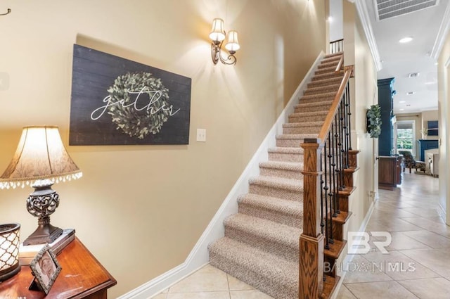 staircase with visible vents, baseboards, tile patterned flooring, crown molding, and recessed lighting