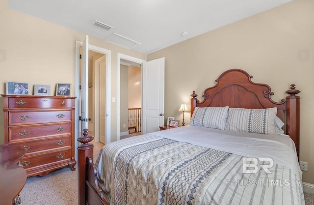 carpeted bedroom with attic access and visible vents