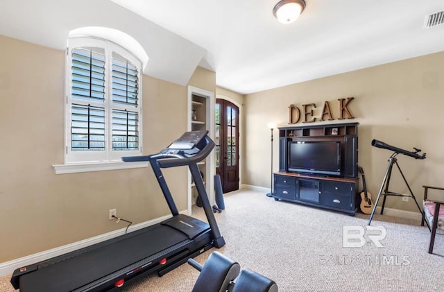 exercise area featuring carpet, baseboards, and visible vents