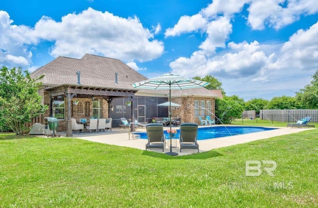 back of property featuring a fenced in pool, fence, a lawn, and a patio