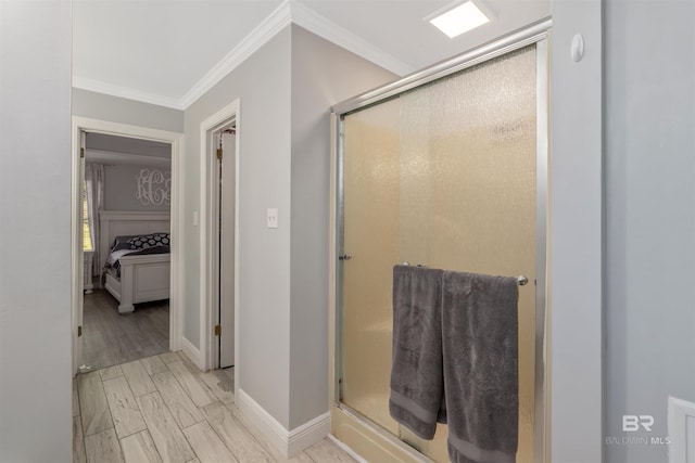 bathroom featuring ornamental molding and a shower with shower door