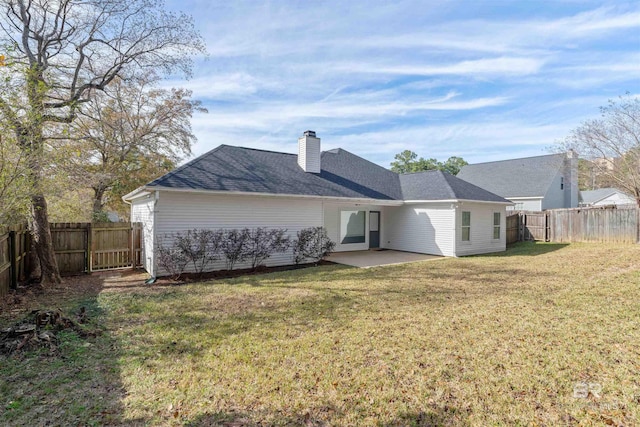 back of house with a lawn and a patio