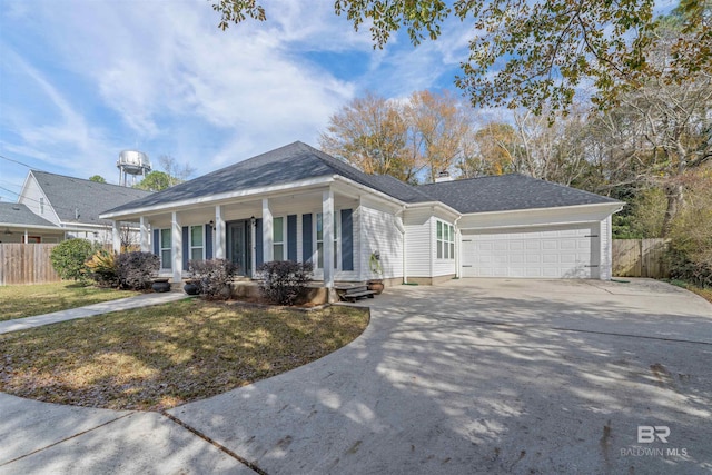 view of front of house featuring a garage, a porch, and a front yard