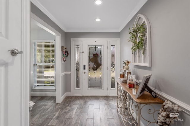 foyer entrance with crown molding and hardwood / wood-style floors