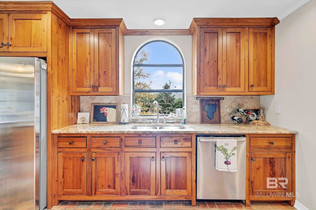 kitchen with ornamental molding, appliances with stainless steel finishes, sink, and decorative backsplash