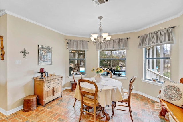 dining space featuring ornamental molding, plenty of natural light, and a chandelier