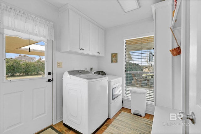 laundry room featuring cabinets, separate washer and dryer, and a wealth of natural light