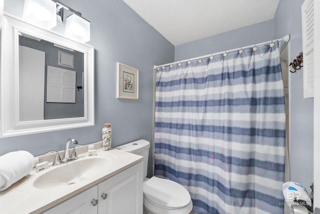 bathroom with a shower with shower curtain, vanity, toilet, and a textured ceiling