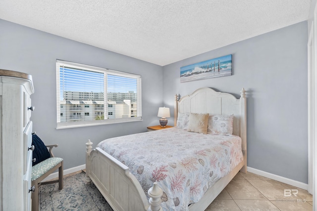 tiled bedroom with a textured ceiling