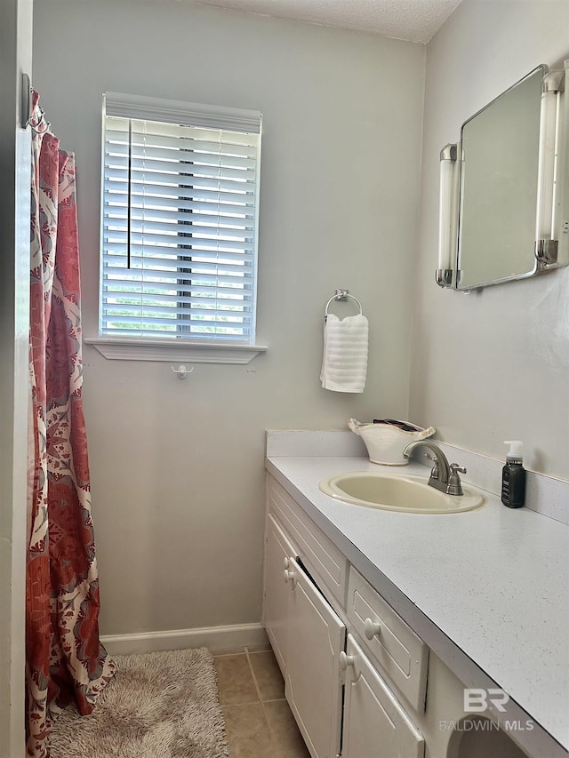 full bathroom featuring tile patterned flooring and vanity