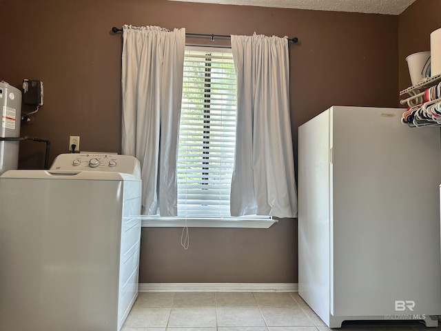washroom featuring washer / dryer, light tile patterned floors, baseboards, and laundry area