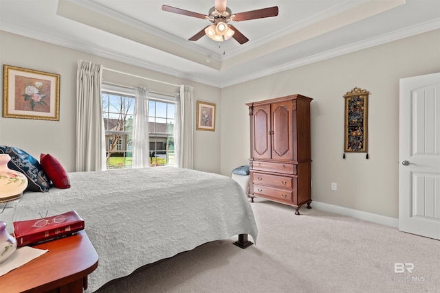 bedroom with a raised ceiling, crown molding, and light carpet