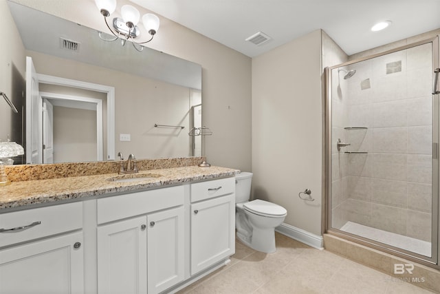 bathroom featuring visible vents, toilet, a stall shower, and vanity