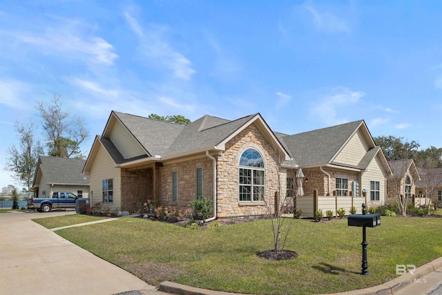 view of front of property with stone siding, roof with shingles, concrete driveway, and a front yard