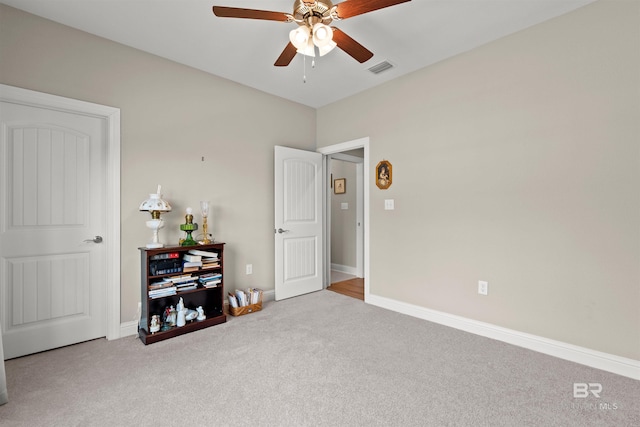 interior space featuring visible vents, a ceiling fan, and baseboards