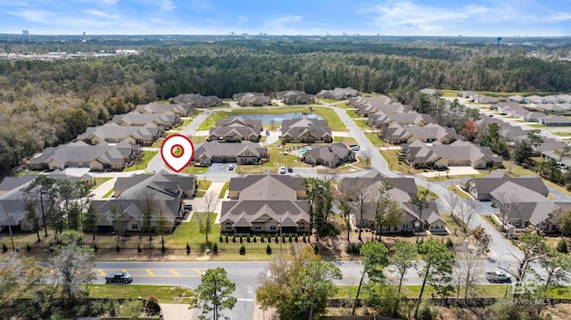 drone / aerial view with a residential view and a view of trees