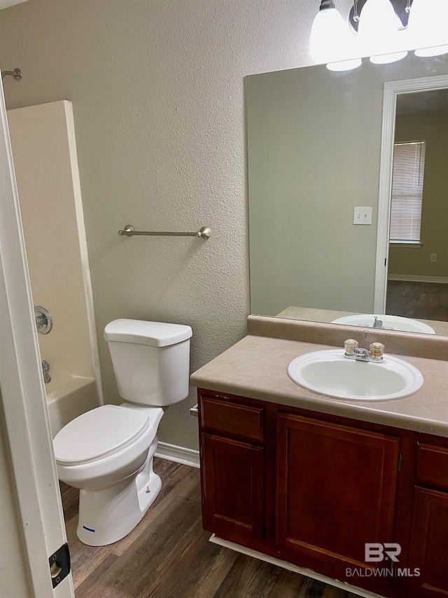 full bathroom featuring vanity, hardwood / wood-style flooring, toilet, and shower / bathtub combination