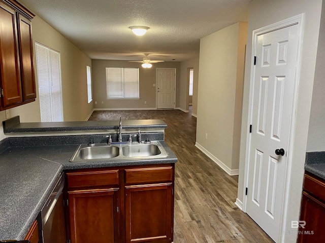 kitchen with a textured ceiling, ceiling fan, sink, dishwasher, and dark hardwood / wood-style floors