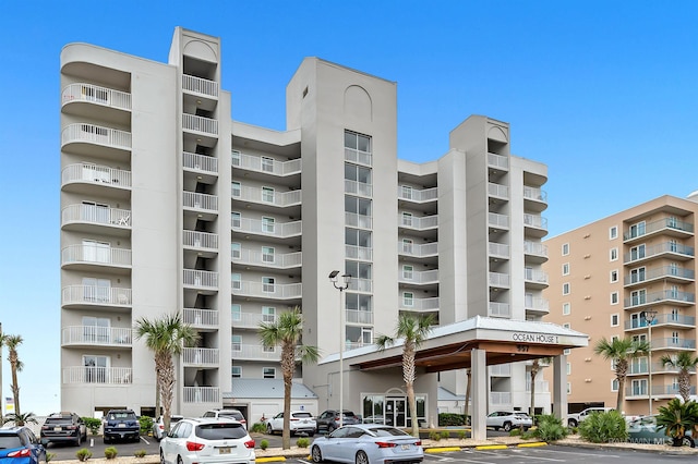 view of building exterior with uncovered parking