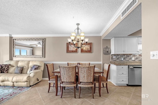 dining area featuring visible vents, ornamental molding, light tile patterned flooring, a textured ceiling, and ceiling fan with notable chandelier