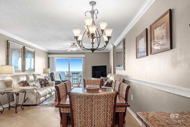 dining area featuring light tile patterned floors, ornamental molding, a textured ceiling, and baseboards