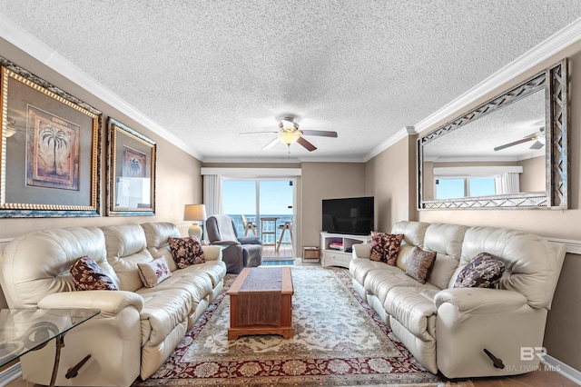 living room featuring a textured ceiling, ornamental molding, and a ceiling fan