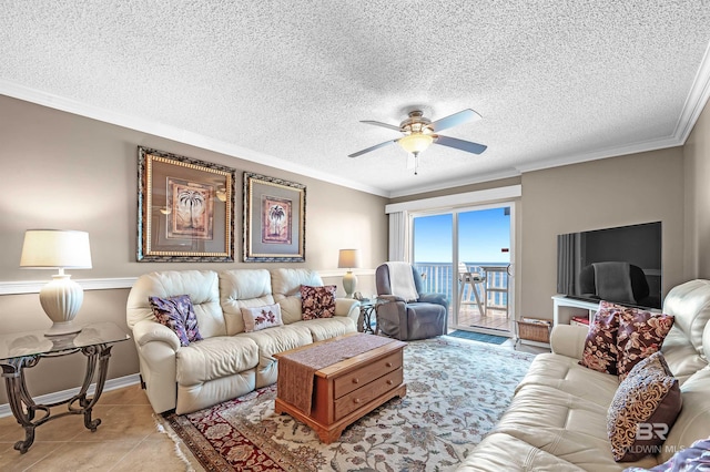 living room with light tile patterned floors, ceiling fan, and crown molding