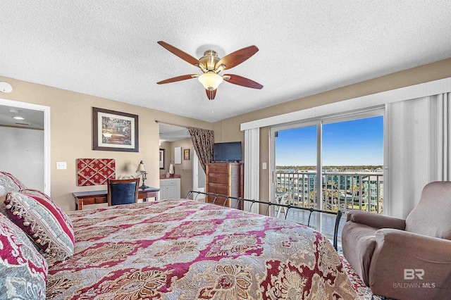 bedroom with access to exterior, a textured ceiling, and a ceiling fan