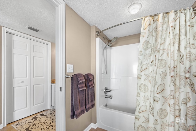 bathroom with a closet, visible vents, shower / bathtub combination with curtain, and a textured ceiling