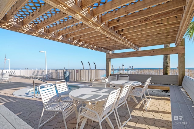 view of patio / terrace with a water view and a community pool