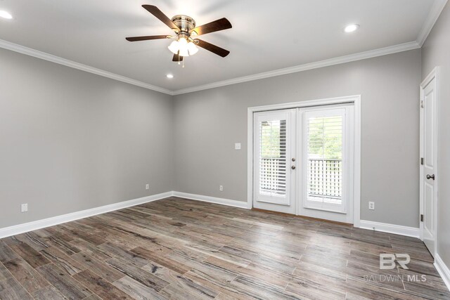 spare room with ornamental molding, ceiling fan, french doors, and hardwood / wood-style flooring