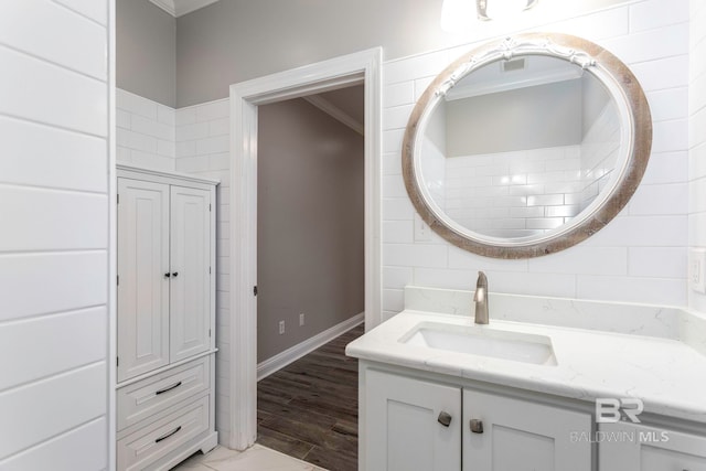 bathroom featuring crown molding, vanity, and hardwood / wood-style floors