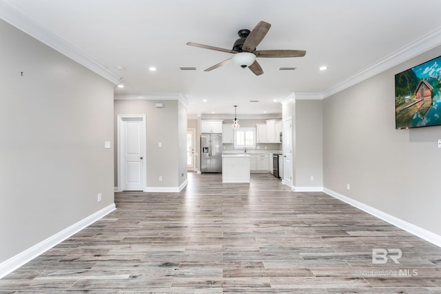 unfurnished living room with light wood-type flooring, ornamental molding, and ceiling fan