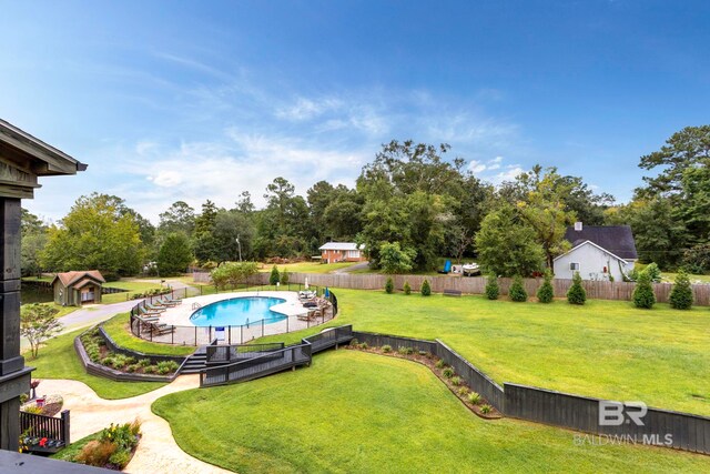 view of swimming pool with a yard and a patio area