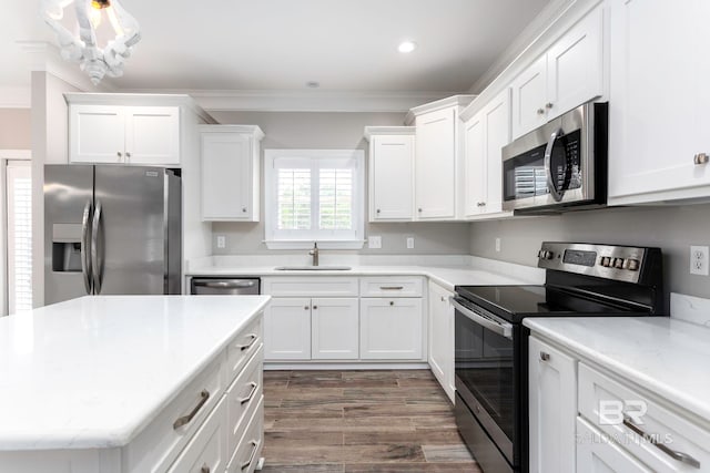 kitchen featuring stainless steel appliances, dark hardwood / wood-style floors, sink, and crown molding