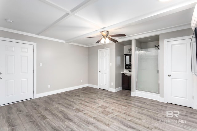 unfurnished bedroom featuring crown molding, ensuite bath, ceiling fan, and light hardwood / wood-style flooring