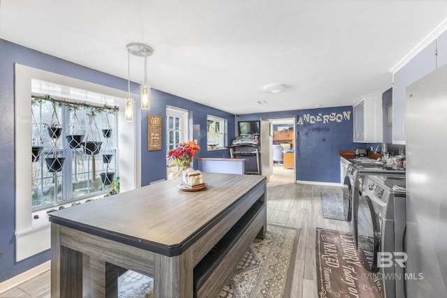 dining room with sink, hardwood / wood-style flooring, and washing machine and dryer