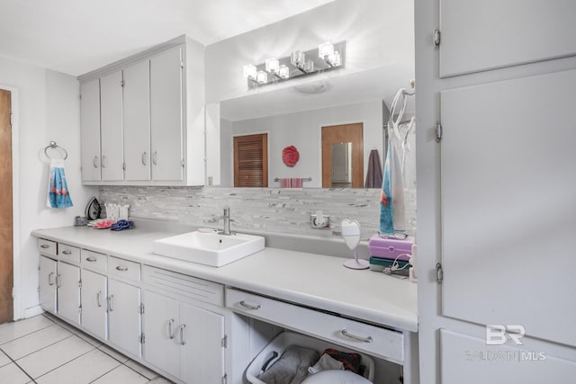 bathroom featuring tile patterned flooring, backsplash, and vanity