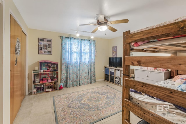 bedroom with ceiling fan, rail lighting, and light tile patterned floors