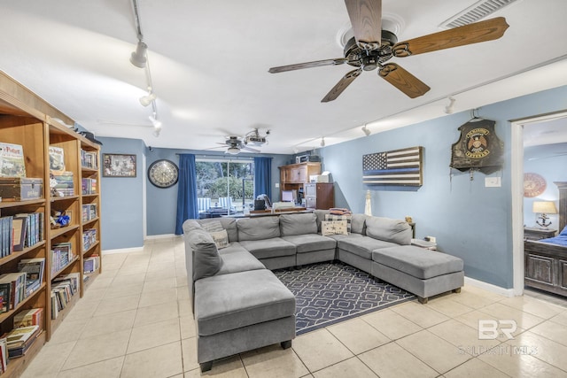 living room with track lighting, ceiling fan, and light tile patterned floors