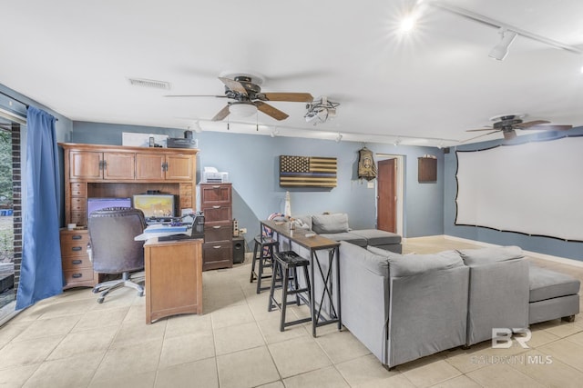 interior space featuring track lighting, ceiling fan, and light tile patterned floors