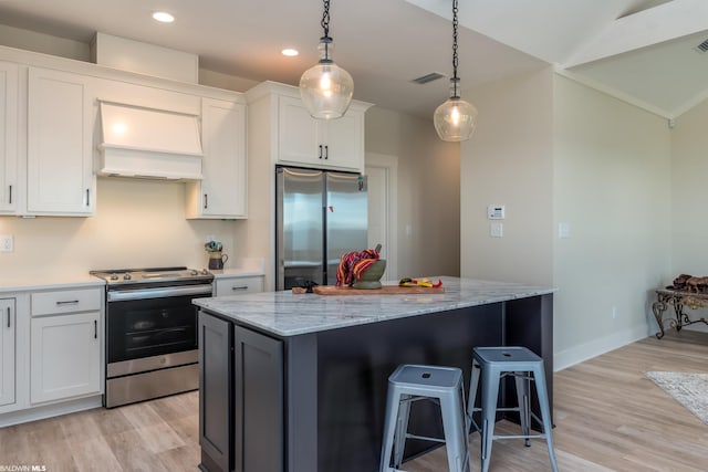 kitchen featuring appliances with stainless steel finishes, white cabinetry, and premium range hood