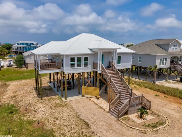 view of front of property with a wooden deck and a patio area