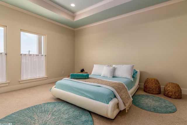 bedroom featuring light carpet and a tray ceiling