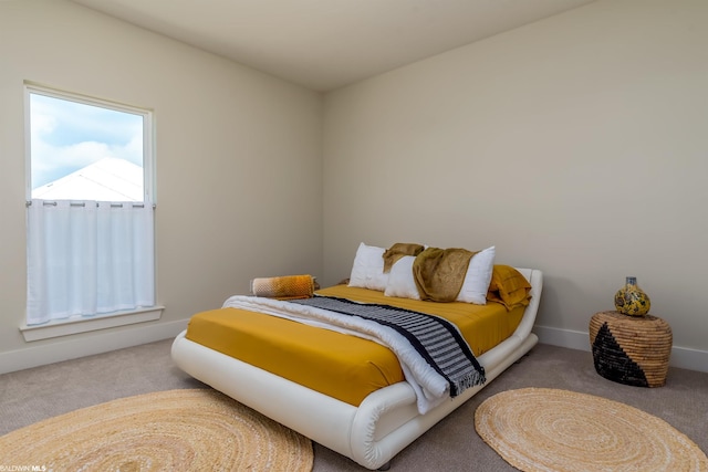 bedroom featuring light colored carpet