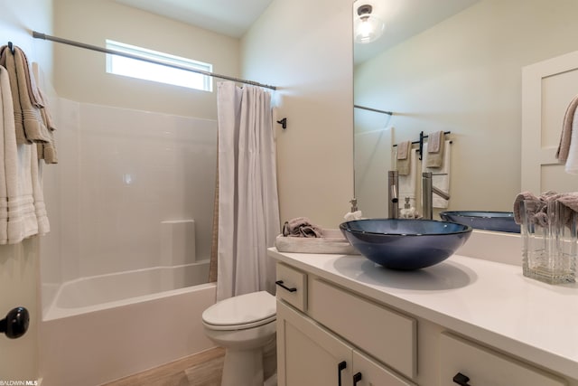 full bathroom with shower / bath combo, toilet, and vanity