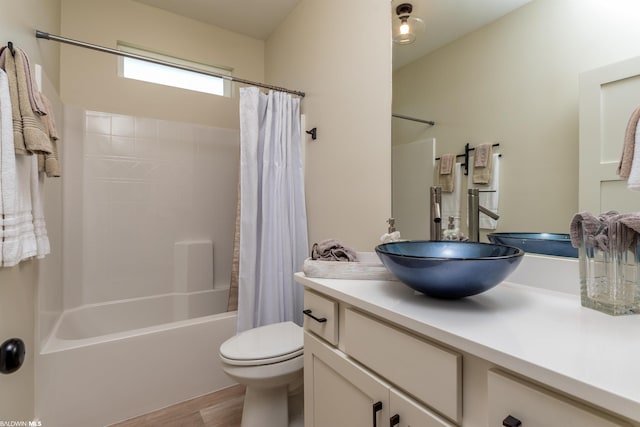 full bathroom with toilet, shower / tub combo, vanity, and wood-type flooring