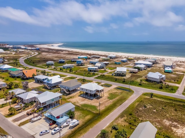 drone / aerial view with a beach view and a water view